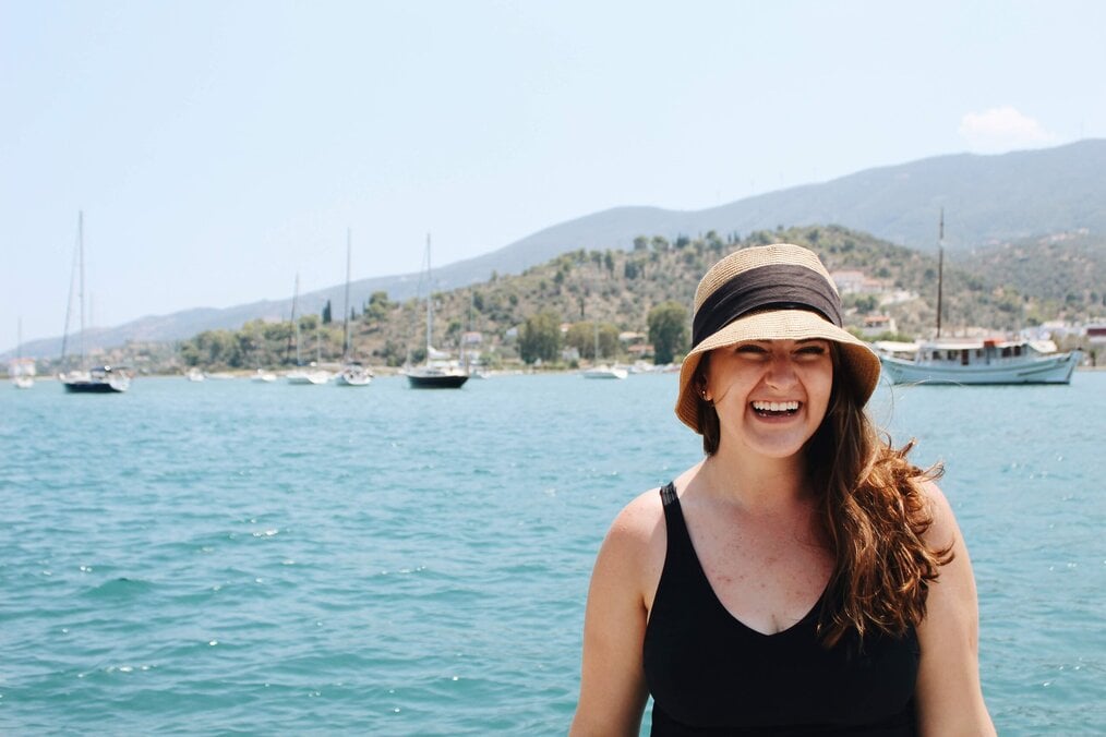 Sarah, CYA Greece Student smiling in front of water
